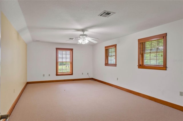 carpeted empty room with ceiling fan and a textured ceiling