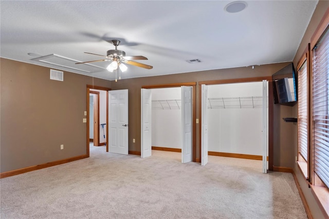 unfurnished bedroom featuring ceiling fan and light carpet