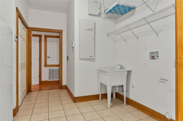 washroom with light tile patterned floors and washer hookup