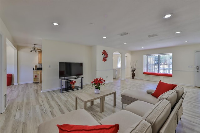 living room featuring light hardwood / wood-style flooring and ceiling fan