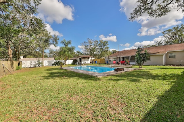 view of pool with a yard