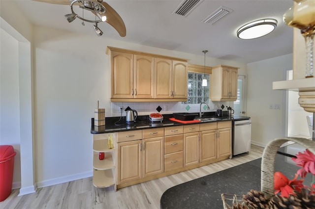 kitchen with dishwasher, tasteful backsplash, hanging light fixtures, sink, and light wood-type flooring