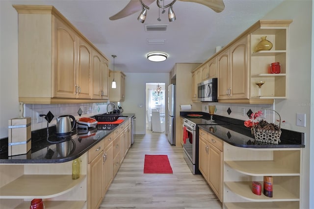 kitchen with ceiling fan, decorative light fixtures, appliances with stainless steel finishes, and decorative backsplash