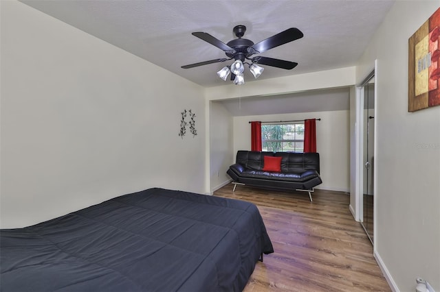 bedroom with ceiling fan and dark hardwood / wood-style flooring