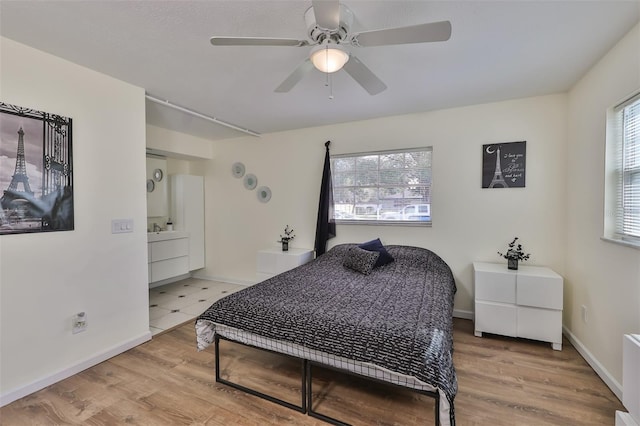 bedroom with ceiling fan, radiator, and light wood-type flooring