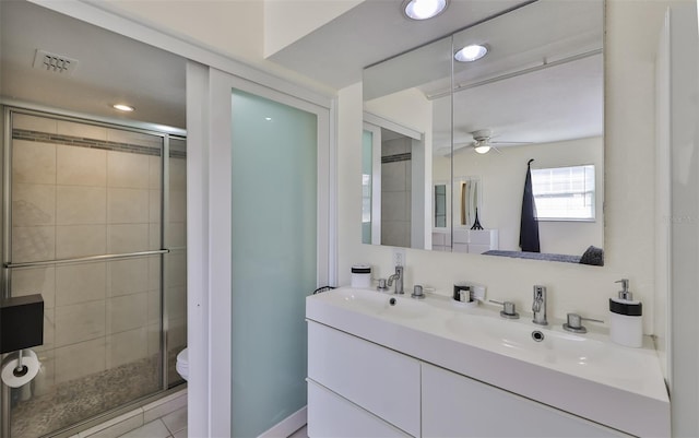 bathroom featuring vanity, toilet, an enclosed shower, and ceiling fan