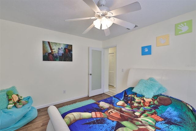 bedroom with wood-type flooring and ceiling fan