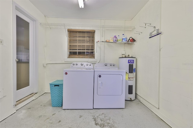 laundry area featuring electric water heater and separate washer and dryer