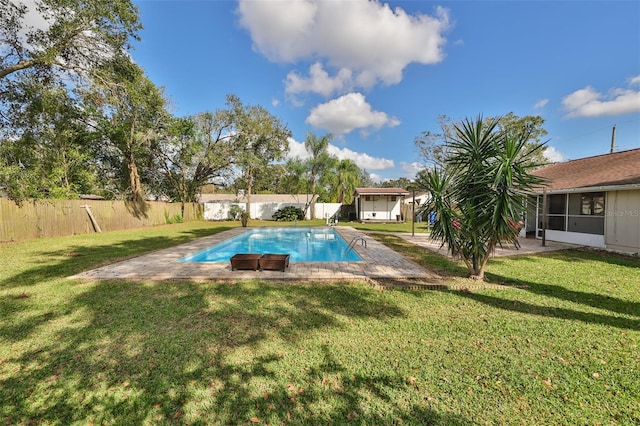 view of pool with a yard and a sunroom