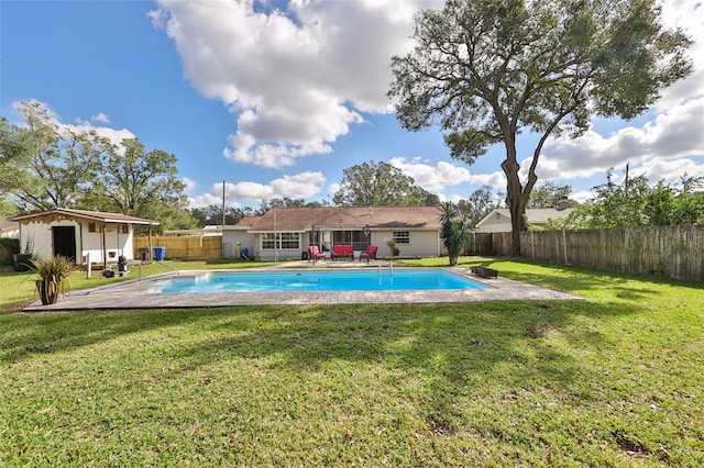 view of pool featuring a lawn and a patio