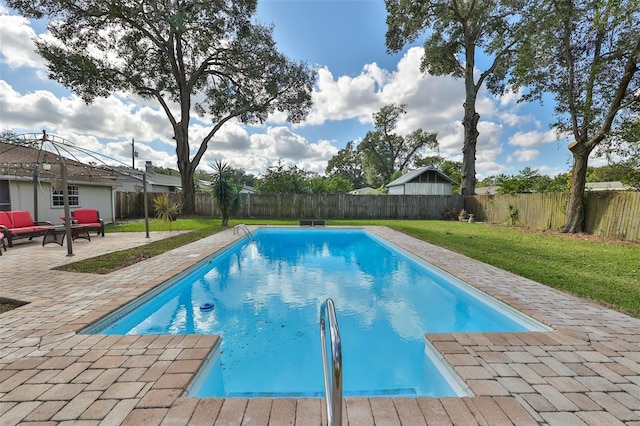 view of swimming pool featuring a lawn and a patio