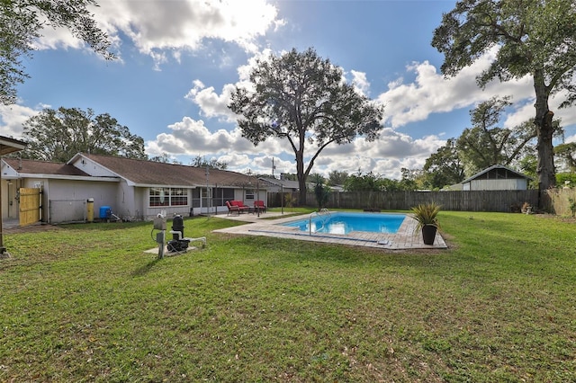 view of swimming pool featuring a lawn and a patio