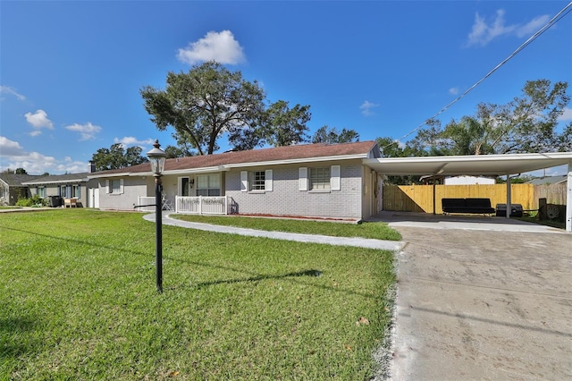 ranch-style home featuring a front yard and a carport