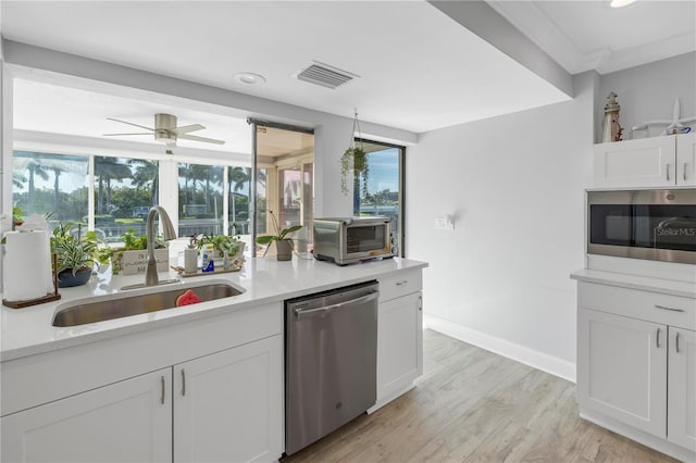 kitchen featuring light hardwood / wood-style flooring, stainless steel appliances, sink, ceiling fan, and white cabinets