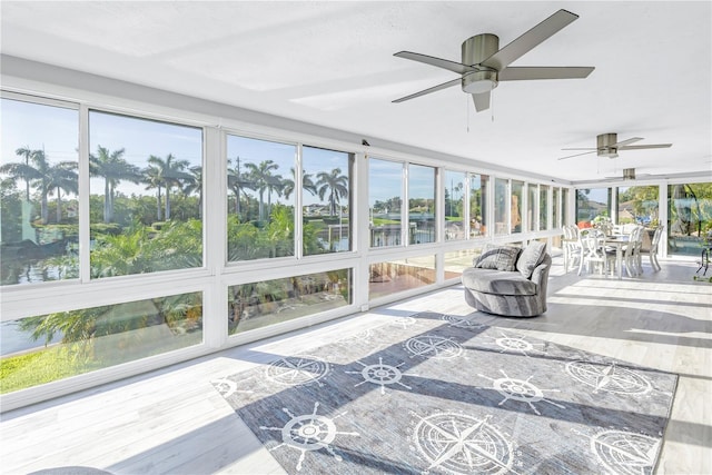 sunroom with a healthy amount of sunlight and ceiling fan