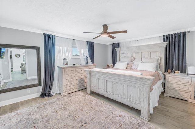 bedroom with ceiling fan and light hardwood / wood-style flooring