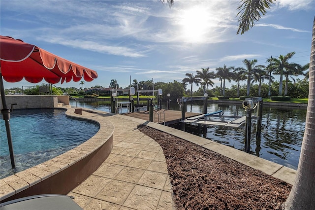 view of pool featuring a water view and a boat dock