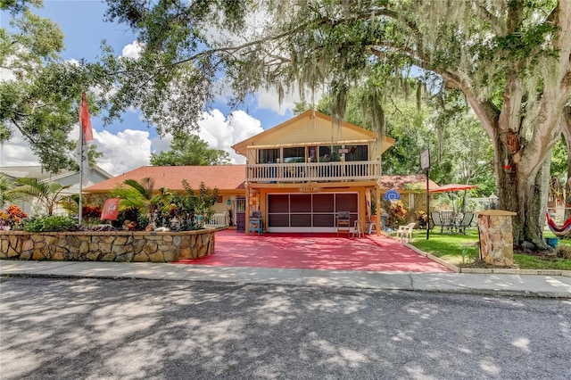 view of property featuring a balcony and a garage