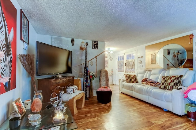 living room featuring wood-type flooring and a textured ceiling