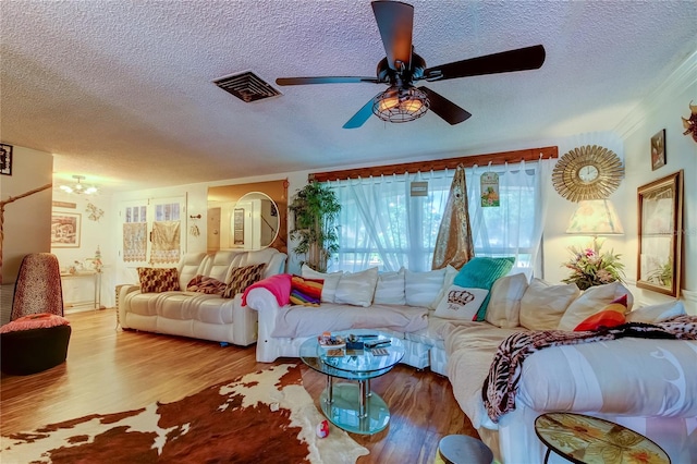 living room featuring a textured ceiling, ceiling fan, and hardwood / wood-style floors