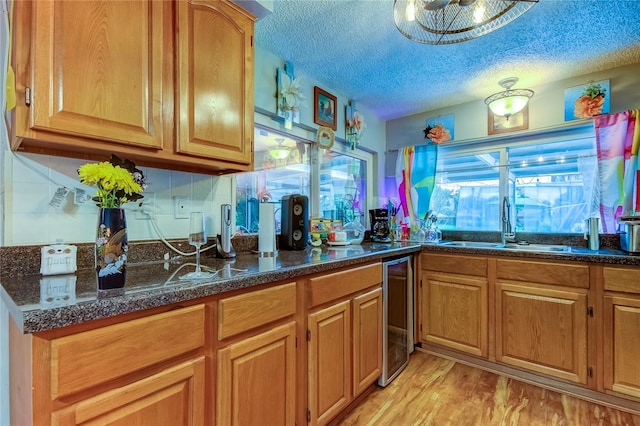 kitchen with a textured ceiling, plenty of natural light, and light wood-type flooring