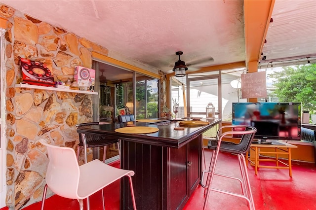 interior space featuring concrete floors and ceiling fan