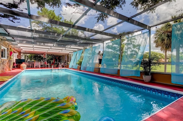 view of swimming pool featuring a lanai