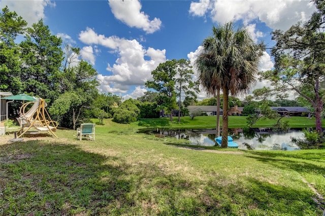 view of yard featuring a water view and a playground