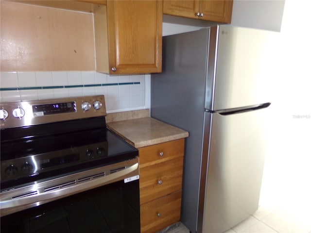 kitchen featuring stainless steel appliances and tasteful backsplash