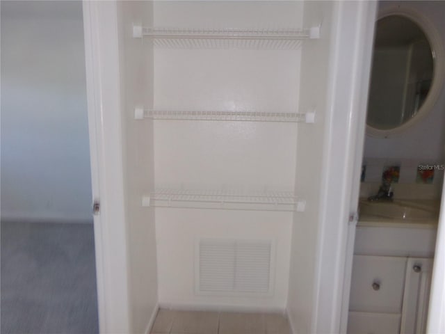 interior space featuring sink and stacked washer / drying machine