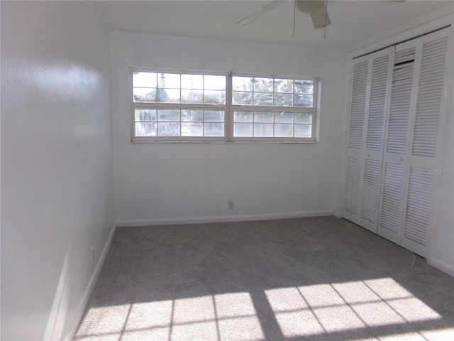 unfurnished bedroom featuring a closet, ceiling fan, and carpet flooring