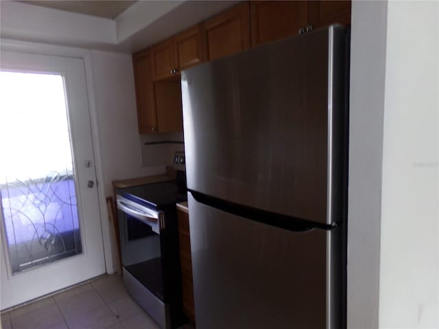 kitchen with stainless steel appliances and light tile patterned floors