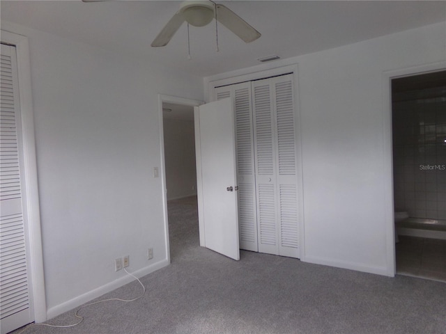 unfurnished bedroom with carpet, ensuite bathroom, and ceiling fan