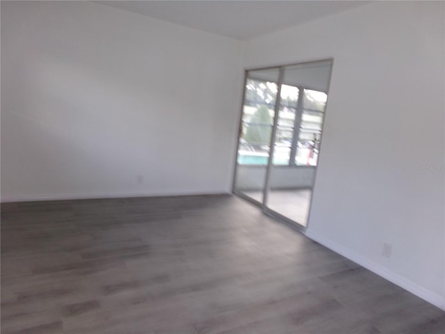 empty room with dark hardwood / wood-style floors