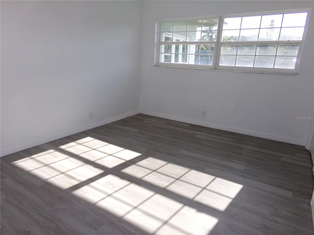 spare room featuring dark hardwood / wood-style floors