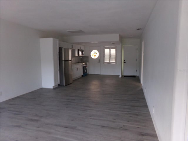 unfurnished living room with wood-type flooring