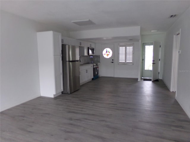 kitchen with white cabinets, decorative light fixtures, appliances with stainless steel finishes, sink, and dark hardwood / wood-style floors