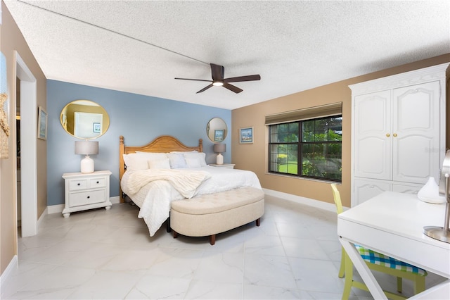 bedroom featuring ceiling fan and a textured ceiling