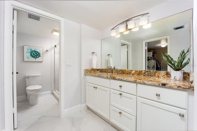 bathroom featuring vanity, toilet, and an enclosed shower