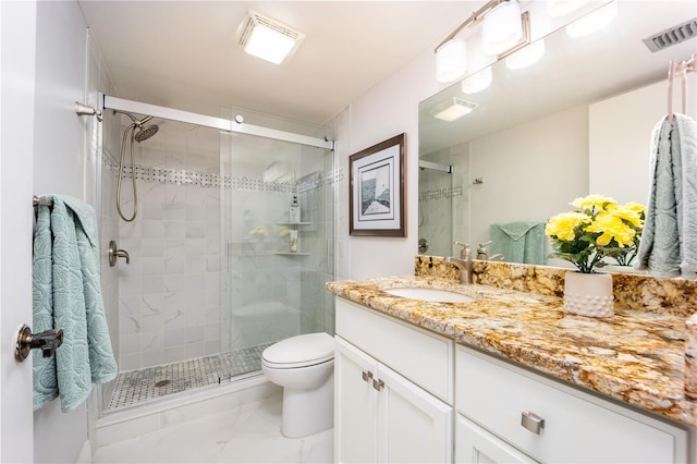 bathroom featuring vanity, toilet, and walk in shower