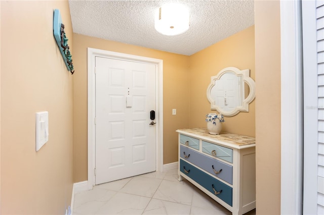 entryway with a textured ceiling