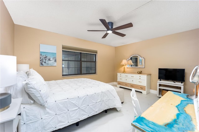 bedroom with ceiling fan and a textured ceiling