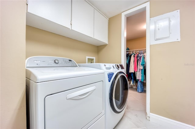 laundry room featuring electric panel, cabinets, and independent washer and dryer