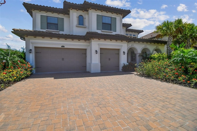 mediterranean / spanish-style home featuring a garage