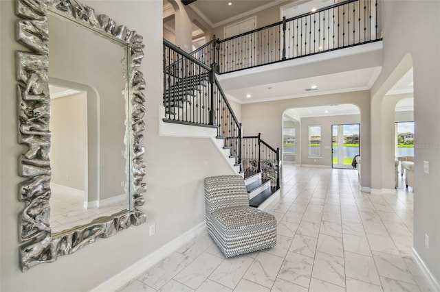 entrance foyer featuring a high ceiling and ornamental molding