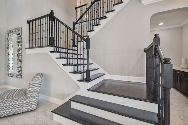 stairs featuring crown molding