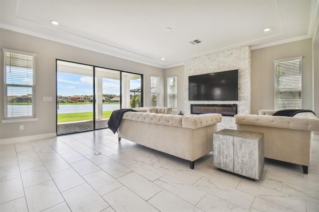 living room featuring ornamental molding and a stone fireplace