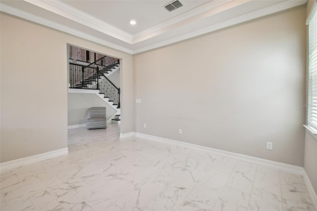 interior space featuring a tray ceiling and crown molding