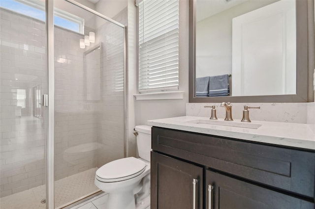 bathroom with walk in shower, toilet, and vanity