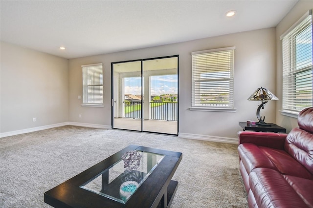 living room with plenty of natural light and carpet flooring